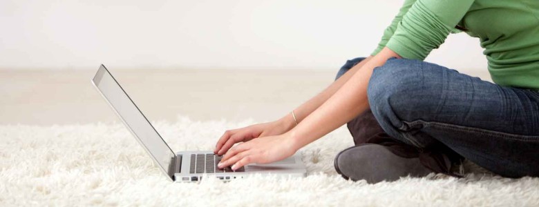 woman with a laptop working from home smiling